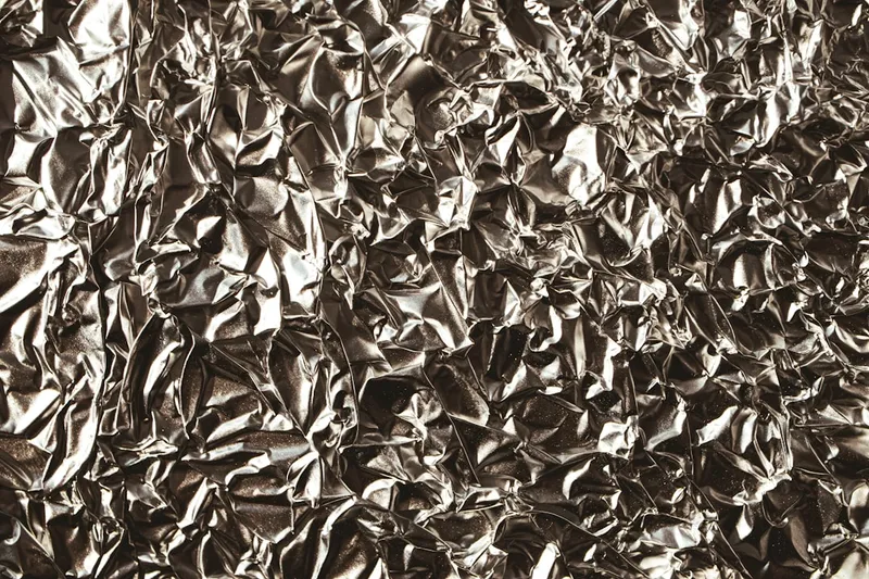 a black and white photo of a metal sheet